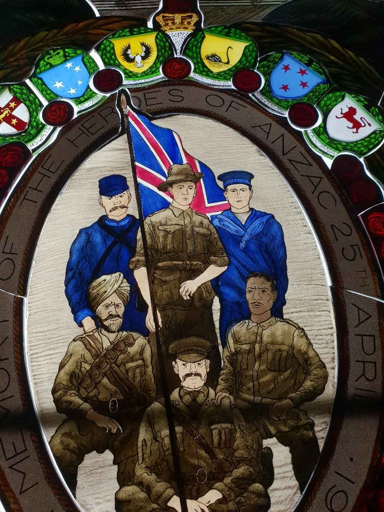 A panel of the window featuring Anzac and multi-cultural Defence personnel, inspired by the design of the order of service from the first Anzac Day service held in 1916