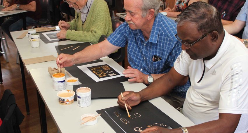 Western Region Clergy Muster: clergy participants engaged in an Aboriginal dot painting