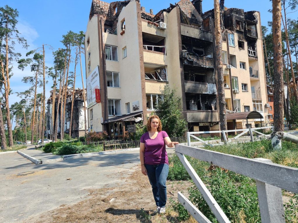 Helen Zahos in front of a bombed building in Ukraine