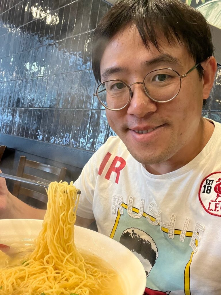 The Rev'd Simon Tang enjoying noodles 
