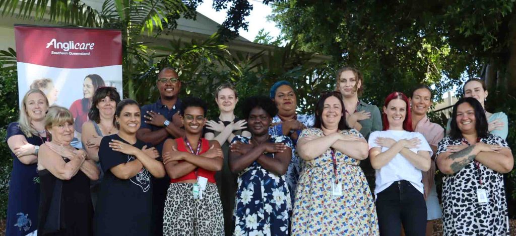 The Toowong Women’s Homelessness Service team in the Embrace Equity pose