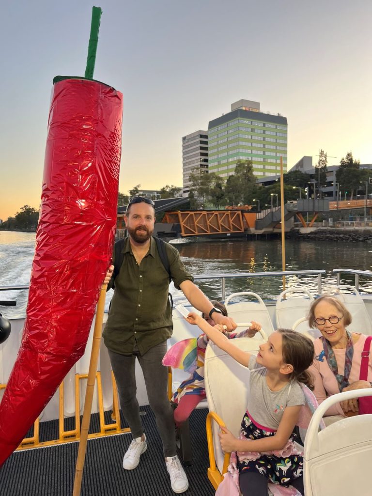 The Rev'd Samuel Dow, pictured with the Baroona Farm crew on the ferry heading to the LUMINOUS Lantern Parade in June 2023