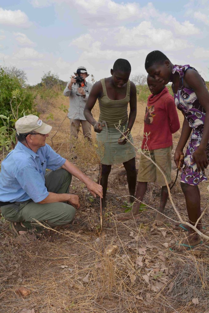 Tony Rinaudo (L) working with locals and teaching tree pruning in Ghana